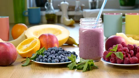 Melon, raspberry and blueberry smoothie in a jar on the background of fresh Stock Footage 157833777