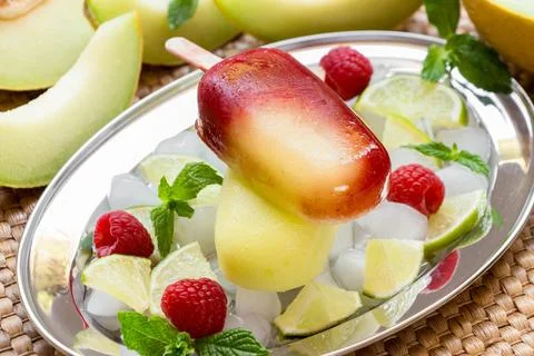 Melon raspberry ice cream served on a silver tray with fresh raspberries, lime Stock Photos