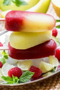 Melon raspberry ice cream served on a silver tray with fresh raspberries, lime Stock Photos