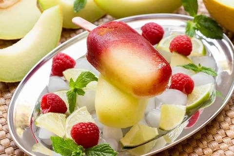 Melon raspberry ice cream on a silver platter garnished with fresh raspberries Stock Photos