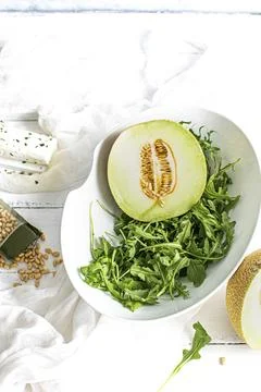 Melon with rocket salad in a bowl Stock Photos