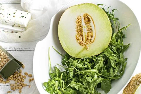 Melon with rocket salad in a bowl Stock Photos