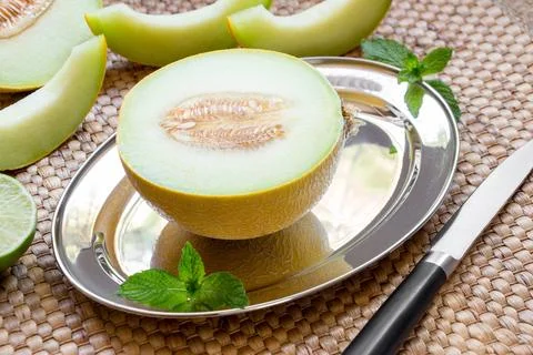 Melon on silver platter. Stock Photos