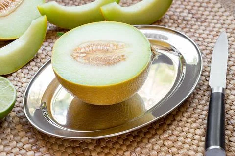 Melon on silver platter. Stock Photos