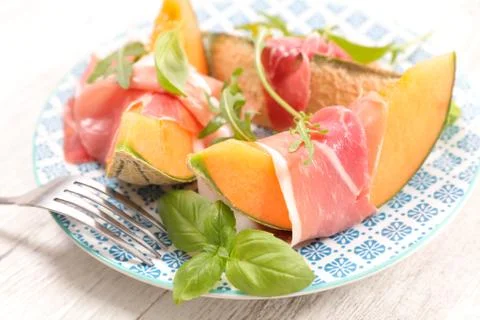 Melon slice with prosciutto Stock Photos
