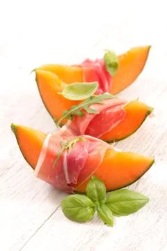 Melon slice with prosciutto Stock Photos