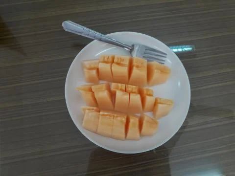Melon sliced in a plate. Stock Photos