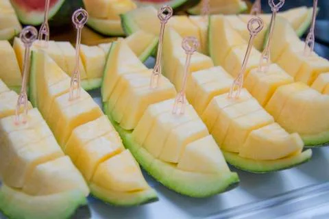 Melon sliced on a tray with a dipper. Stock Photos