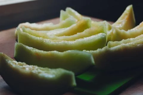 Melon slices on the kitchen table by the window Stock Photos