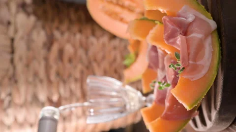 Melon slices with prosciutto ham on board Stock Footage 202276482