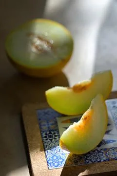 Melon with slices on a table Stock Photos