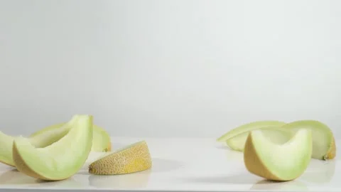 Melon splits on white table Stock Footage 145792986