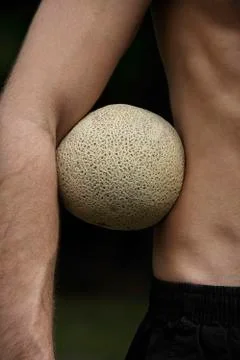 Melon under man's arm Stock Photos