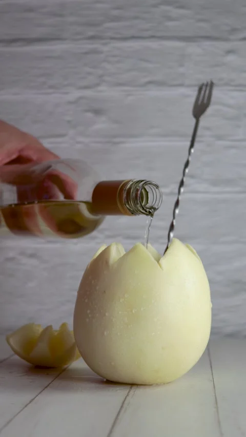 Melon with wine, melvin, preparing, cocktail, adding, white wine. On white wo Stock Footage 258414737