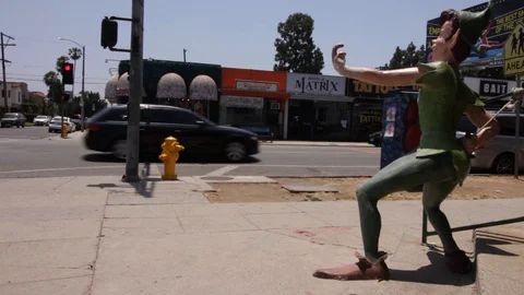 Melrose Intersection traffic and Peter Pan Statue - Los Angeles, CA Stock Footage 91311410