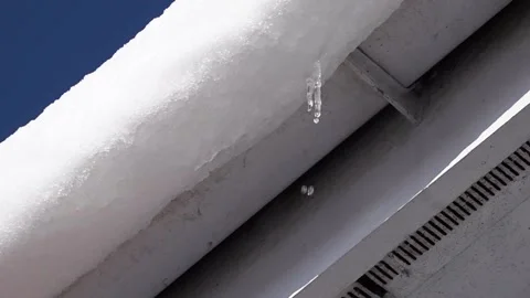 Melt water dripping from a rooftop Stock Footage 147232027