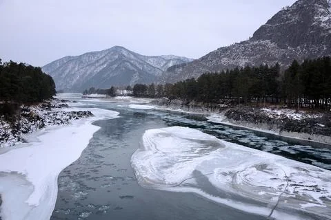 The melted bed of a small river flowing from the mountains in a stone sleev.. Stock Photos
