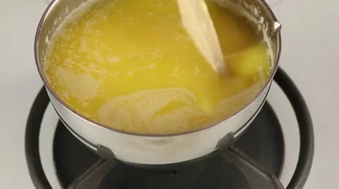 Melted butter being stirred in a pot Stock Footage 24671453