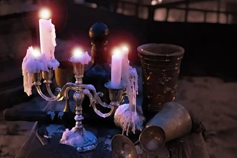 Melted candles in on old table   dark Halloween scene Stock Photos