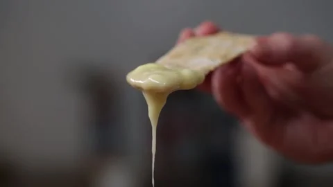 Melted Cheese Dripping from Cracker Stock Footage 166862946
