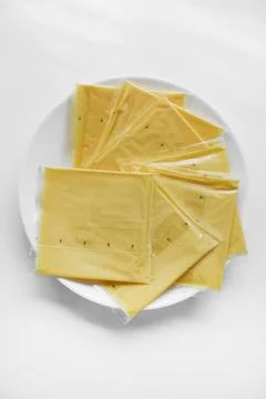 Melted cheese in flat slices. Processed cream cheese for sandwiches. 写真素材