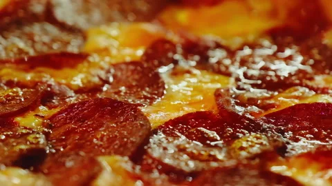 Melted cheese spreads smoothly across surface of hot pizza Stock Footage 326369308