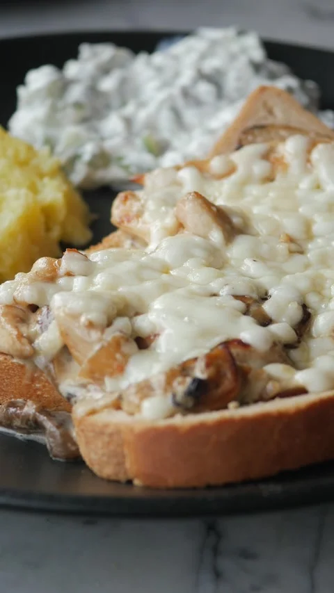 Melted cheese on toasted bread with chicken Stock Footage 337143150