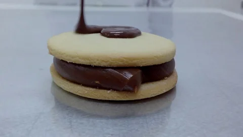 Melted chocolate on an alfajor Stock Footage 87857501