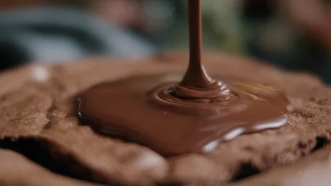Melted chocolate being poured onto a cake Stock Footage 114934158