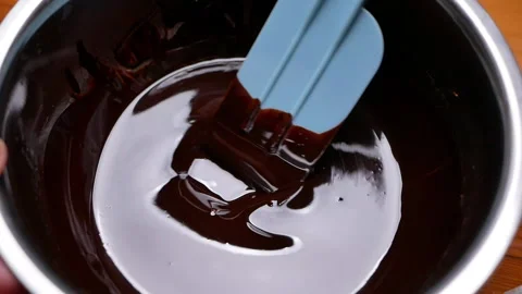 Melted chocolate in a bowl, preparing for making brownie or chocolate cake. Видео 158660360