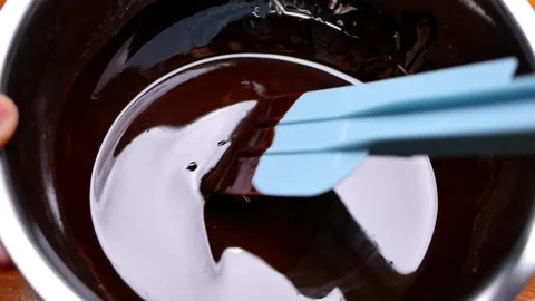 Melted chocolate in a bowl, preparing for making brownie or chocolate cake. Stock Footage 158660439