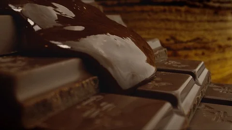 Melted chocolate flows down the chocolate bars. Stock Footage 119468148