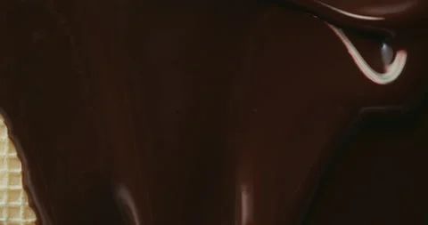 Melted chocolate flows over wafer surface. Cooking dessert. Confectionery Stock Footage 151557247