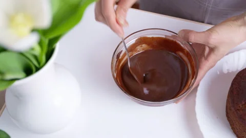 The melted chocolate is mixed with a spoon. Stock Footage 152743136