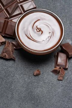 Melted chocolate or Hazelnut spread in glass bowl and chocolate pieces on dark Stock Photos