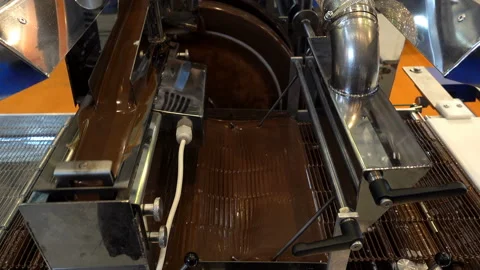 Melted chocolate is poured into a candy machine in 4K Stock Footage 128224328
