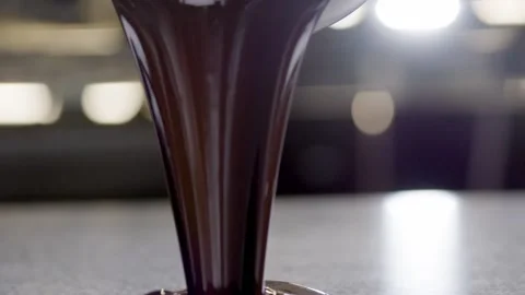 Melted Chocolate Pouring on Counter Stock Footage 152470109