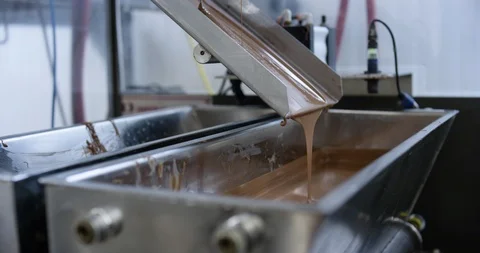 Melted chocolate pouring into a machine Stock Footage 104002278