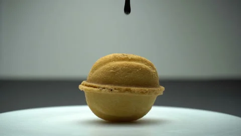 Melted chocolate pouring to nutlet. Liquid tasty sweet dessert cooking Stock Footage 86993683