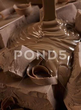 Melted Chocolate Pouring Over Chocolate Chunks