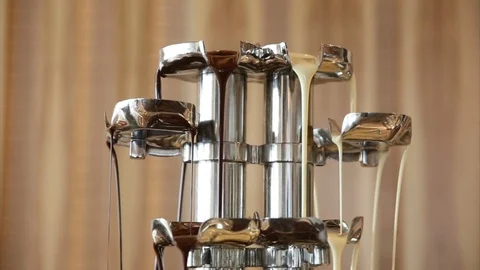 Melted chocolate pouring over chunks of chocolate (2) Stock Footage 126892456