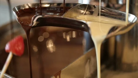 Melted chocolate pouring over chunks of chocolate Video stock 126892504