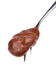 Melted chocolate on a spoon Stock Photos