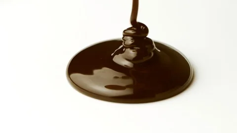 Melted chocolate syrup on white background in slow motion Stock-Footage 114308135