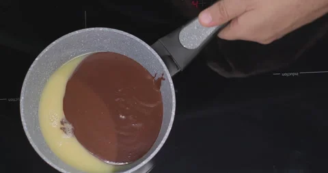 Melted chocolate white and dark in a pan. Preparation of melted chocolate white Stock Footage 252718708