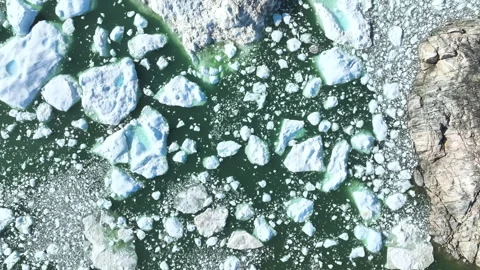 Melted Chunks of Ice Near Rocks Aerial Stock Footage 292940968