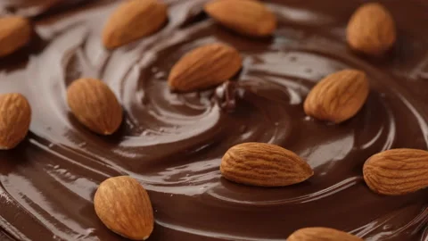 Melted dark chocolate and nuts almond rotating Stock-Footage 138975199
