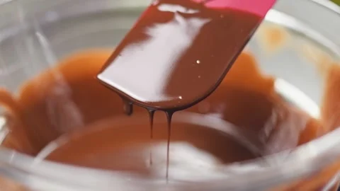Melted dark chocolate with butter. Process of preparing a mixture for lava cake. Stock Footage 152529309