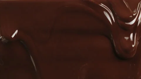 Melted liquid chocolate flows, flowing molten chocolate or dark caramel stream Video stock 151795978