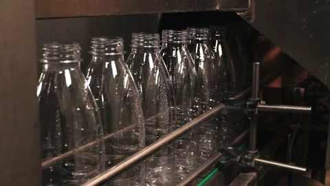 Melted milk is poured into empty plastic bottles on the conveyor Stock Footage 170667723